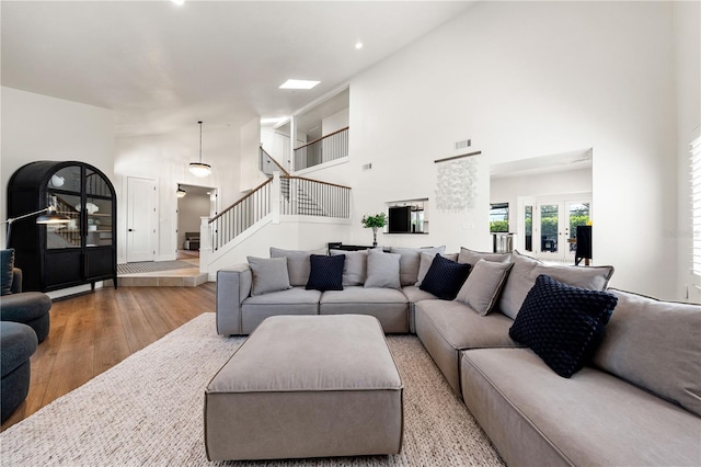 1484 Seafarer Dr, Osprey, FL 34229 - living area featuring wood finished floors, a high ceiling, stairway, and recessed lighting