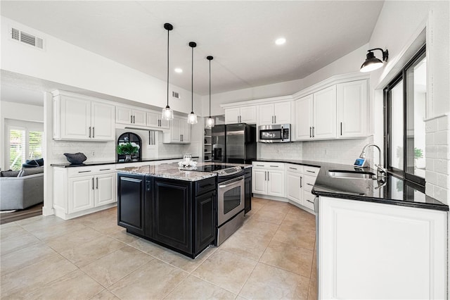 1484 Seafarer Dr, Osprey, FL 34229 - kitchen featuring stainless steel appliances, dark cabinets, white cabinets, decorative backsplash, and light tile patterned floors