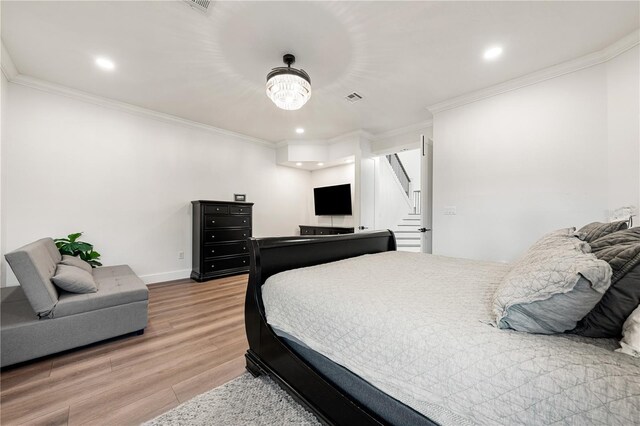 1484 Seafarer Dr, Osprey, FL 34229 - bedroom with light wood-style floors, ornamental molding, and recessed lighting