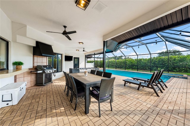 1484 Seafarer Dr, Osprey, FL 34229 - view of patio featuring area for grilling, a ceiling fan, glass enclosure, outdoor dining area, and a pool with connected hot tub