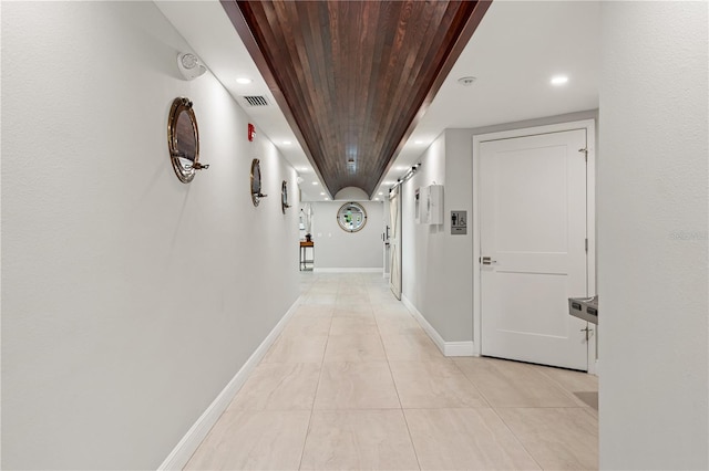 1484 Seafarer Dr, Osprey, FL 34229 - hall with wooden ceiling, recessed lighting, and light tile patterned flooring