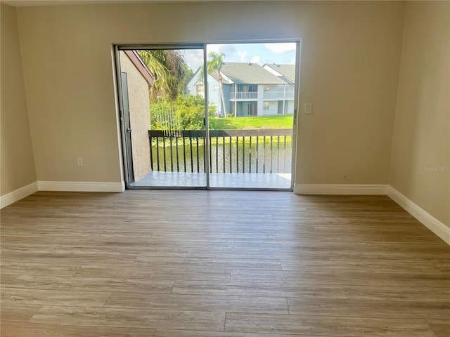 2636 Hidden Lake Dr N Unit G, Sarasota, FL 34237 - unfurnished room with baseboards and wood finished floors