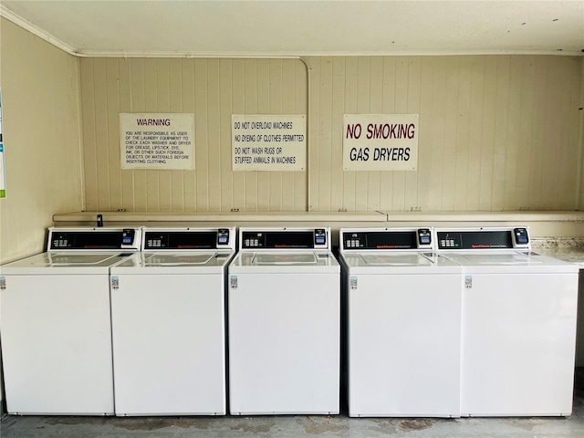 2636 Hidden Lake Dr N Unit G, Sarasota, FL 34237 - shared laundry room with wood walls, washer and clothes dryer, and crown molding