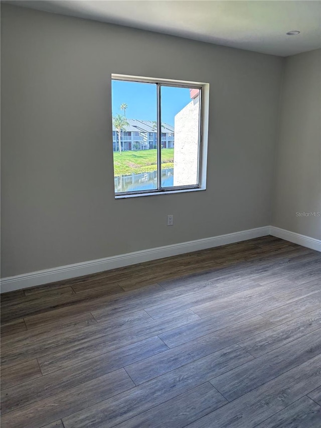 2636 Hidden Lake Dr N Unit G, Sarasota, FL 34237 - empty room with dark wood finished floors