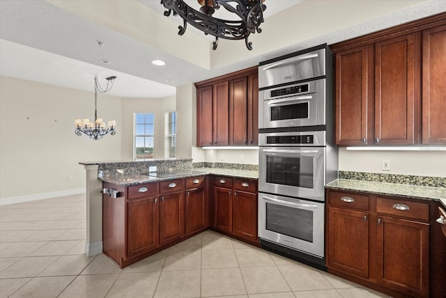 5100 Jessie Harbor Dr Unit 701, Osprey, FL 34229 - kitchen featuring a chandelier, stainless steel double oven, light tile patterned floors, a peninsula, and recessed lighting