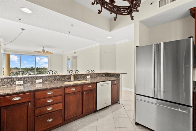 5100 Jessie Harbor Dr Unit 701, Osprey, FL 34229 - kitchen featuring appliances with stainless steel finishes, dark stone countertops, light tile patterned floors, a chandelier, and recessed lighting