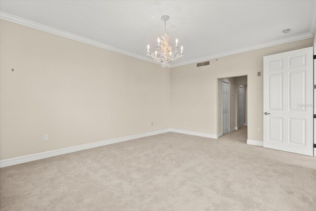 5100 Jessie Harbor Dr Unit 701, Osprey, FL 34229 - spare room featuring a chandelier, light colored carpet, and crown molding