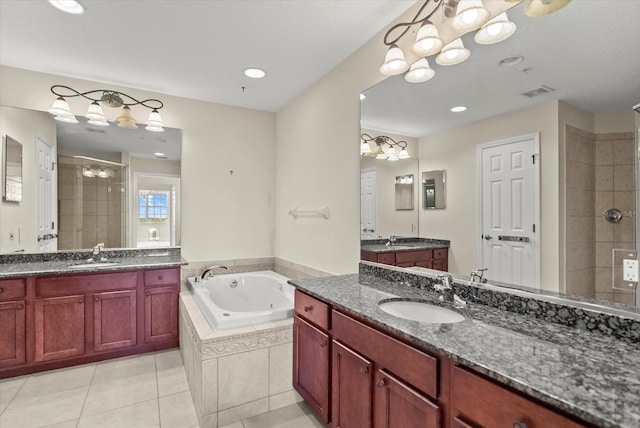 5100 Jessie Harbor Dr Unit 701, Osprey, FL 34229 - full bath featuring a shower stall, a tub with jets, two vanities, a chandelier, and tile patterned floors