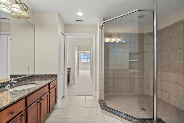 5100 Jessie Harbor Dr Unit 701, Osprey, FL 34229 - bathroom featuring vanity, a shower stall, and tile patterned floors