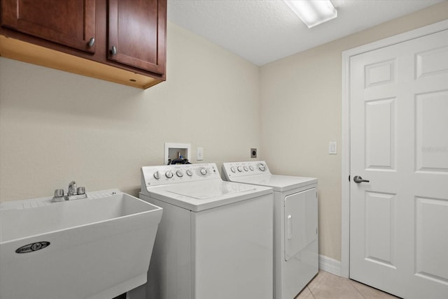 5100 Jessie Harbor Dr Unit 701, Osprey, FL 34229 - laundry area with cabinet space, separate washer and dryer, light tile patterned floors, and a textured ceiling