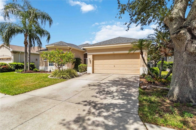 315 36th St NE, Bradenton, FL 34208 - ranch-style house with stucco siding, concrete driveway, a garage, and a front yard