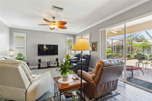 315 36th St NE, Bradenton, FL 34208 - living area featuring a ceiling fan, crown molding, and wood finished floors