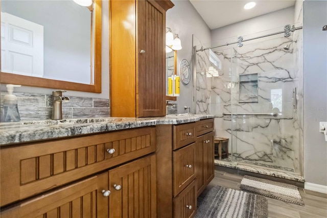 315 36th St NE, Bradenton, FL 34208 - full bathroom with a marble finish shower, double vanity, and wood finished floors