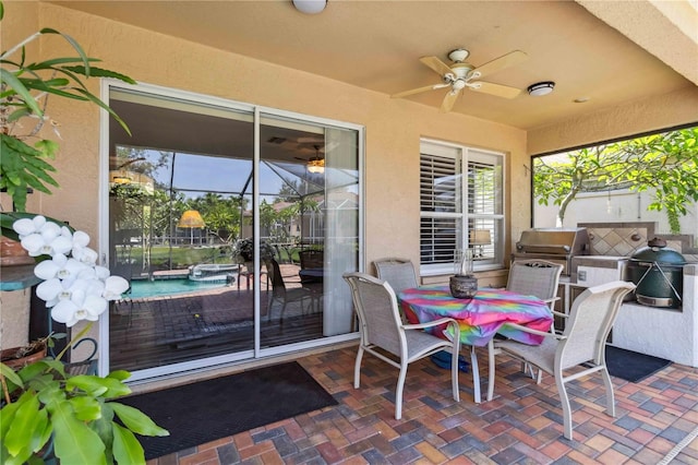 315 36th St NE, Bradenton, FL 34208 - view of patio / terrace featuring ceiling fan, outdoor dining area, a pool with connected hot tub, a lanai, and an outdoor kitchen
