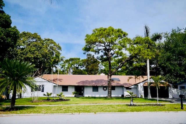1112 Montezuma Dr, Bradenton, FL 34209 - view of front of home with a front yard and a metal roof