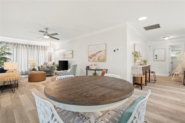 1112 Montezuma Dr, Bradenton, FL 34209 - dining room with crown molding, light wood-style flooring, and a ceiling fan