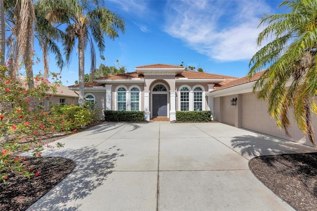 8102 Waterview Blvd, Lakewood Ranch, FL 34202 - mediterranean / spanish home with concrete driveway, stucco siding, a garage, and a tile roof