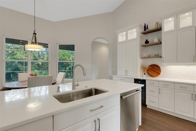 8102 Waterview Blvd, Lakewood Ranch, FL 34202 - kitchen with stainless steel dishwasher, beverage cooler, open shelves, decorative backsplash, and plenty of natural light