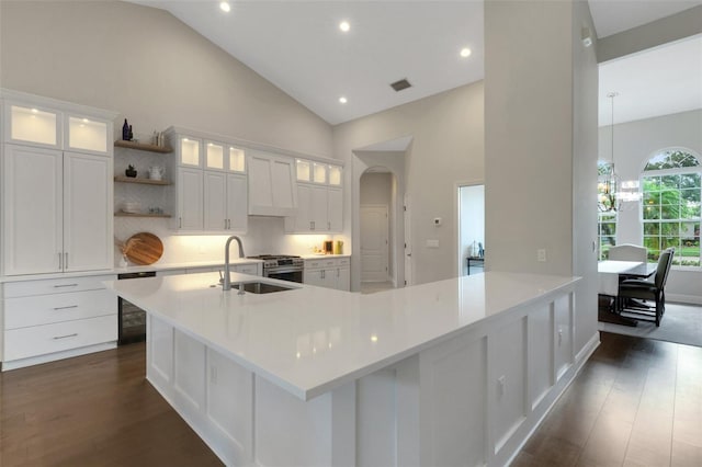 8102 Waterview Blvd, Lakewood Ranch, FL 34202 - kitchen featuring dark wood-style flooring, open shelves, high vaulted ceiling, a chandelier, and white cabinets