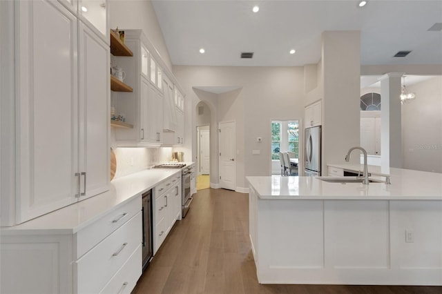 8102 Waterview Blvd, Lakewood Ranch, FL 34202 - kitchen featuring stainless steel appliances, open shelves, white cabinets, recessed lighting, and light countertops