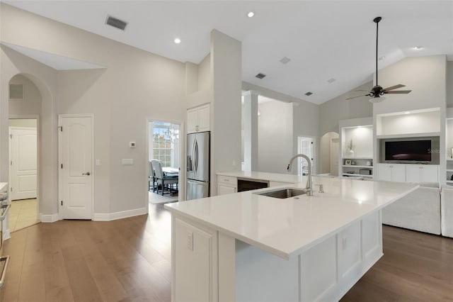 8102 Waterview Blvd, Lakewood Ranch, FL 34202 - kitchen featuring arched walkways, stainless steel fridge with ice dispenser, high vaulted ceiling, wood finished floors, and recessed lighting