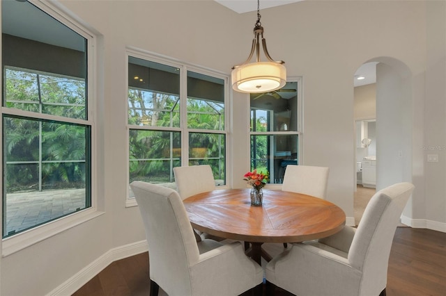 8102 Waterview Blvd, Lakewood Ranch, FL 34202 - dining area featuring arched walkways and dark wood-style flooring