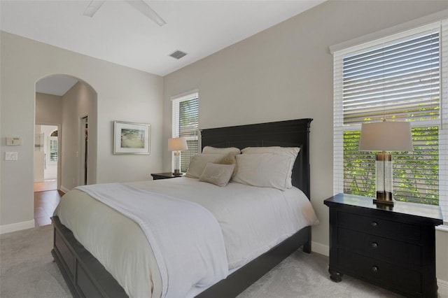 8102 Waterview Blvd, Lakewood Ranch, FL 34202 - bedroom featuring light carpet, arched walkways, and a ceiling fan