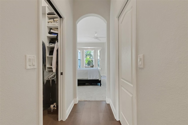 8102 Waterview Blvd, Lakewood Ranch, FL 34202 - hall featuring dark wood-type flooring, arched walkways, and a textured wall