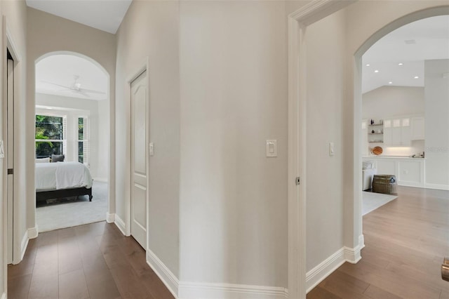 8102 Waterview Blvd, Lakewood Ranch, FL 34202 - hallway featuring arched walkways, dark wood-style floors, and recessed lighting