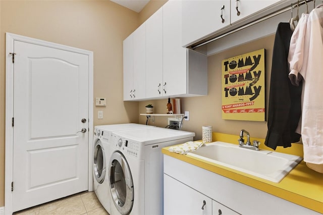 8102 Waterview Blvd, Lakewood Ranch, FL 34202 - laundry area with cabinet space, washer and clothes dryer, and light tile patterned floors