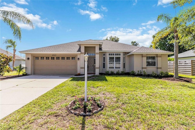 4845 Post Pointe Dr, Sarasota, FL 34233 - view of front of home with stucco siding, an attached garage, driveway, and roof with shingles