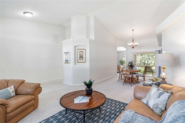 4845 Post Pointe Dr, Sarasota, FL 34233 - living room with carpet flooring, a chandelier, high vaulted ceiling, and arched walkways
