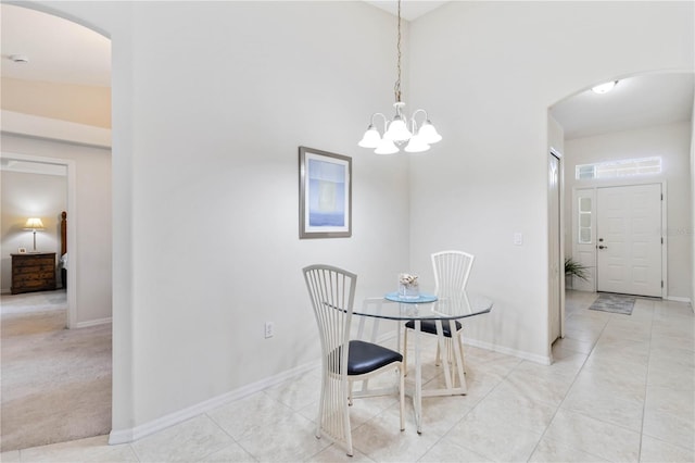 4845 Post Pointe Dr, Sarasota, FL 34233 - dining space featuring arched walkways, light tile patterned floors, and a chandelier