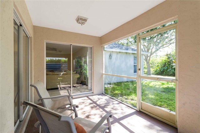 4845 Post Pointe Dr, Sarasota, FL 34233 - sunroom featuring a textured wall and wood finished floors
