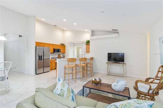 4845 Post Pointe Dr, Sarasota, FL 34233 - living area with recessed lighting, high vaulted ceiling, light tile patterned floors, and arched walkways