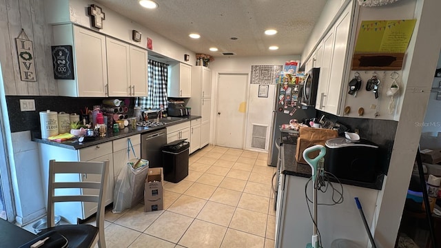 23067 Elmira Blvd, Punta Gorda, FL 33980 - kitchen featuring appliances with stainless steel finishes, recessed lighting, light tile patterned floors, white cabinets, and dark countertops