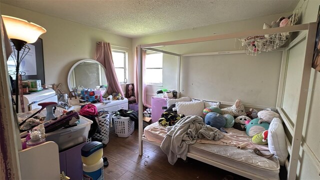 23067 Elmira Blvd, Punta Gorda, FL 33980 - bedroom with hardwood / wood-style flooring and a textured ceiling