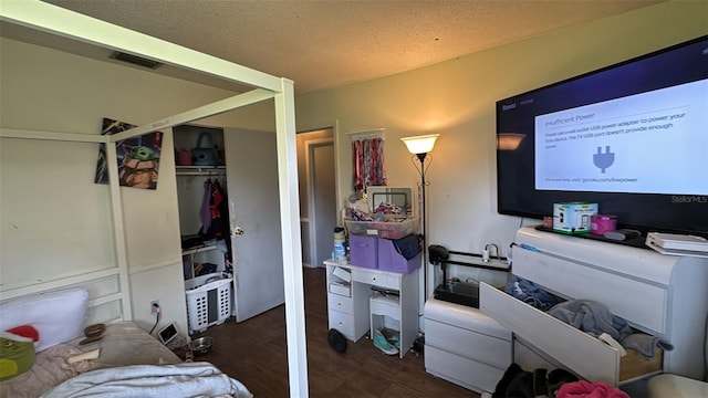 23067 Elmira Blvd, Punta Gorda, FL 33980 - bedroom with wood finished floors, a closet, and a textured ceiling