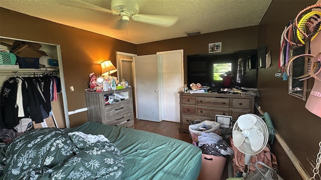 23067 Elmira Blvd, Punta Gorda, FL 33980 - bedroom with a closet, wood finished floors, a textured ceiling, and a ceiling fan