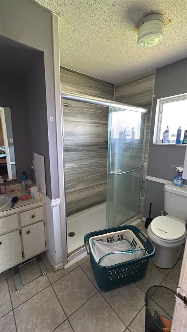 23067 Elmira Blvd, Punta Gorda, FL 33980 - full bath featuring tile patterned flooring, a textured ceiling, a shower stall, and vanity