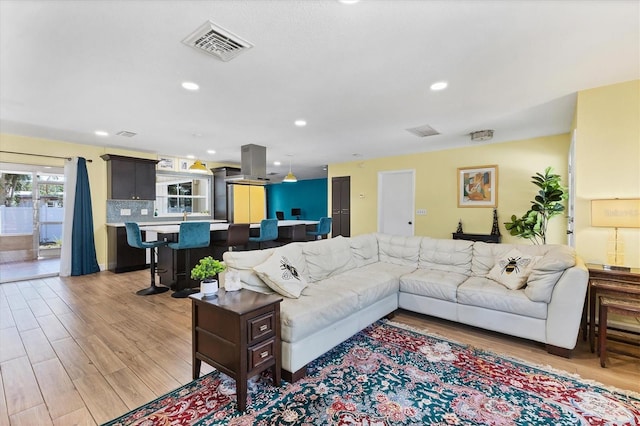 2866 E Rainbow Cir, Sarasota, FL 34231 - living area with light wood-style flooring and recessed lighting