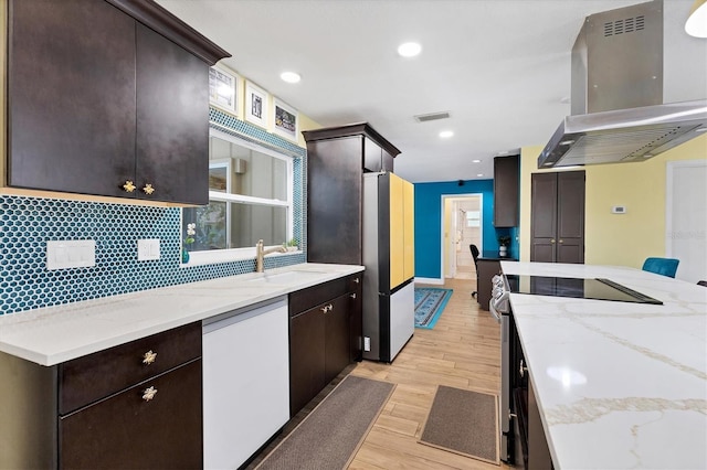 2866 E Rainbow Cir, Sarasota, FL 34231 - kitchen featuring island exhaust hood, electric stove, white dishwasher, freestanding refrigerator, and light wood-type flooring