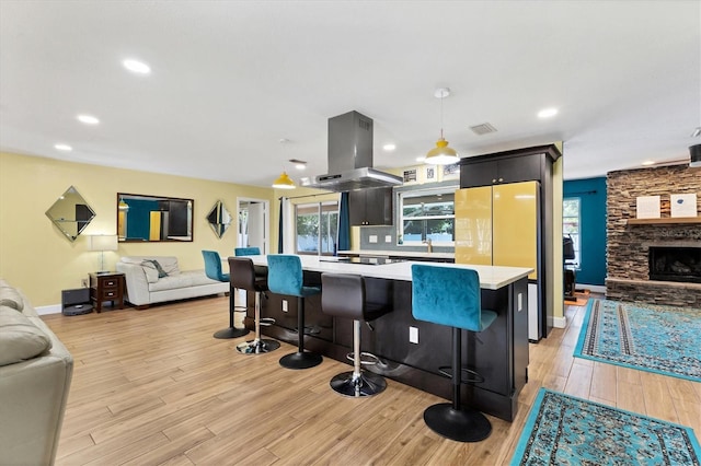 2866 E Rainbow Cir, Sarasota, FL 34231 - kitchen featuring island range hood, open floor plan, light countertops, and recessed lighting