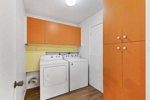 2866 E Rainbow Cir, Sarasota, FL 34231 - laundry room featuring cabinet space, washing machine and dryer, and wood finished floors