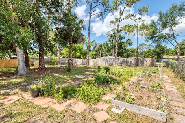 2866 E Rainbow Cir, Sarasota, FL 34231 - fenced backyard featuring a garden