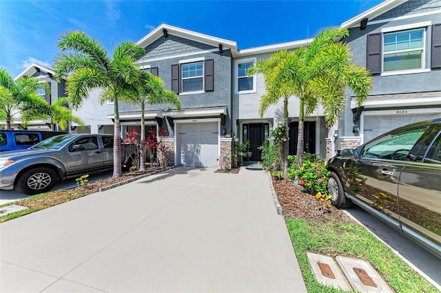 8676 Ice Wine St, Sarasota, FL 34238 - multi unit property with an attached garage, driveway, stucco siding, and stone siding