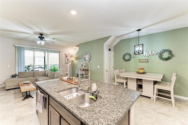 8676 Ice Wine St, Sarasota, FL 34238 - kitchen featuring a chandelier, dishwasher, light tile patterned floors, pendant lighting, and a kitchen island with sink