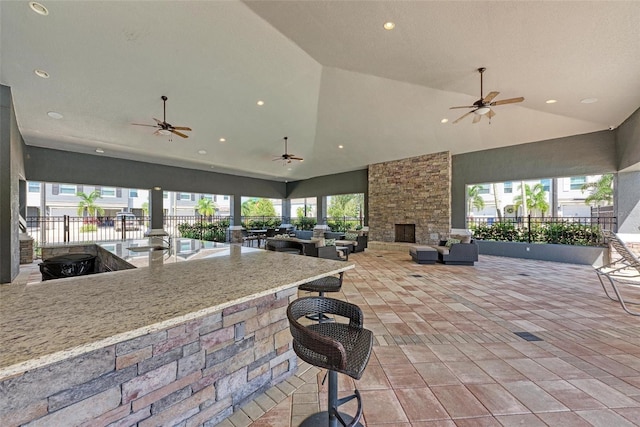 8676 Ice Wine St, Sarasota, FL 34238 - view of patio with exterior bar, a ceiling fan, and an outdoor living space with a fireplace