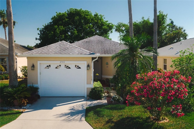 2511 Lantana Ln, Palmetto, FL 34221 - ranch-style home featuring driveway, stucco siding, an attached garage, and roof with shingles