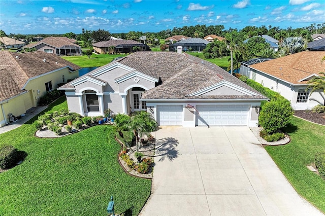 11915 Oak Ridge Dr, Parrish, FL 34219 - view of front of house with an attached garage, driveway, a residential view, and a front yard